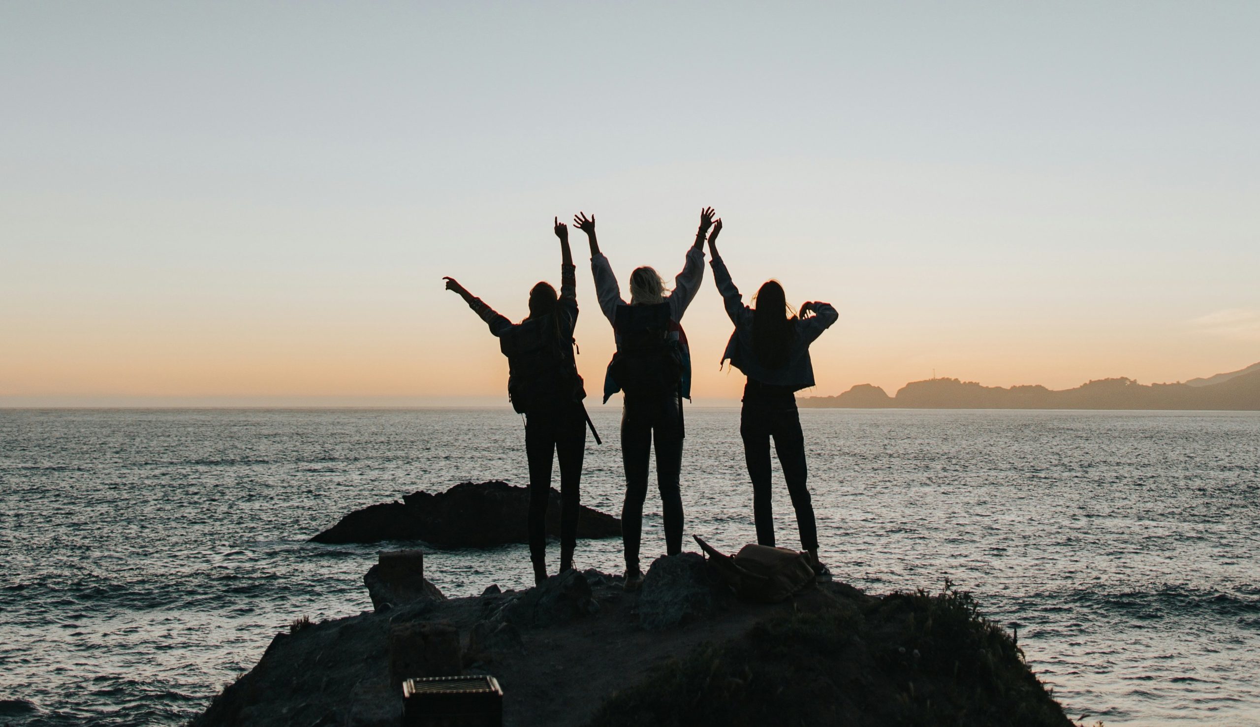 Empowered woman silhouette raising hands in the air, symbolizing strength during menopause