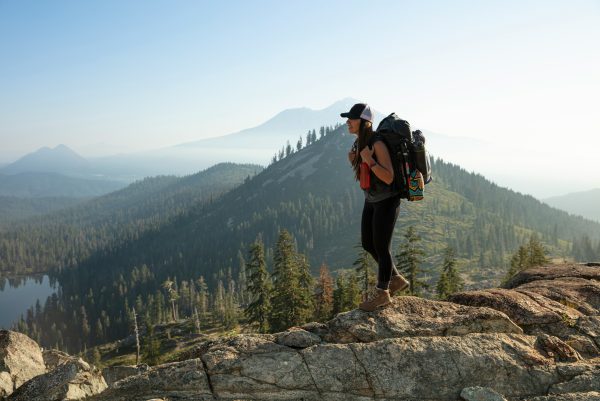 Woman hiking on a mountain trail, embracing movement and strength during perimenopause