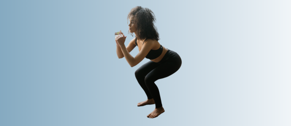 Midlife woman doing a squat as part of strength training for perimenopause support