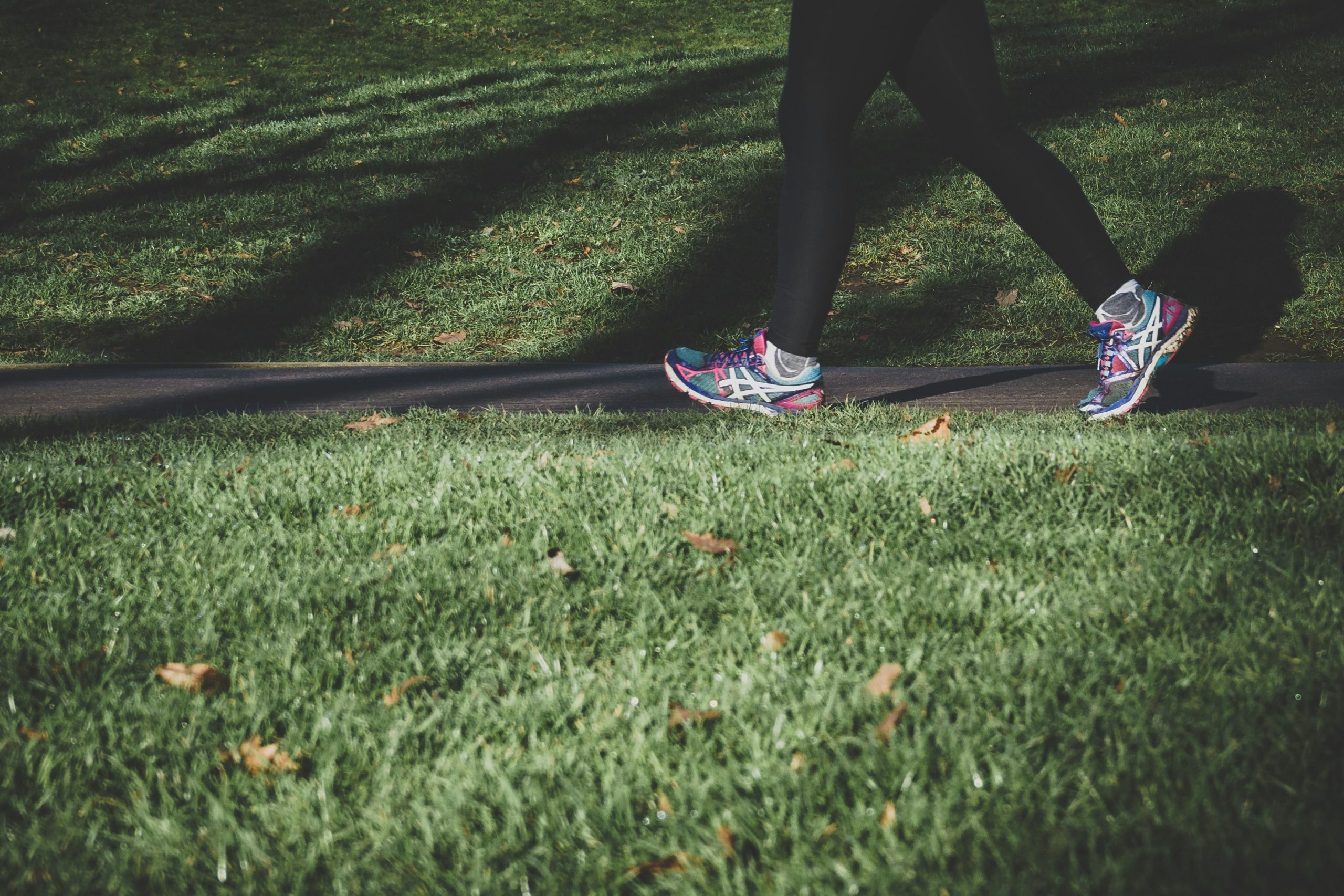 Woman walking on a park path for gentle exercise during perimenopause