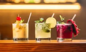 Colourful cocktails on a bar — alcohol choices that can trigger menopause symptoms