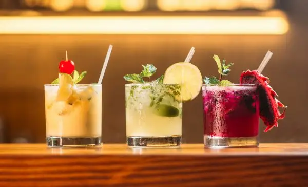 Colourful cocktails on a bar — alcohol choices that can trigger menopause symptoms