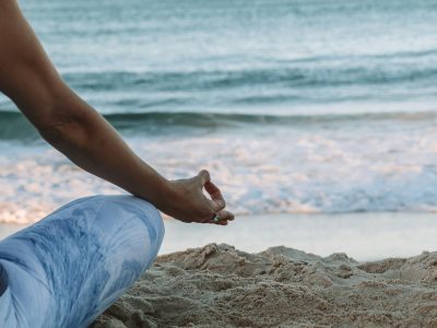 Lady meditating in nature, practicing mindfulness for wellbeing and perimenopause relief. Surrounded by calm natural surroundings, she embodies peace and balance, focusing on inner health, stress reduction, and holistic wellness during perimenopause.