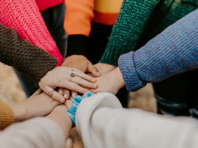 Hands coming together symbolizing support and connection in the menopause community